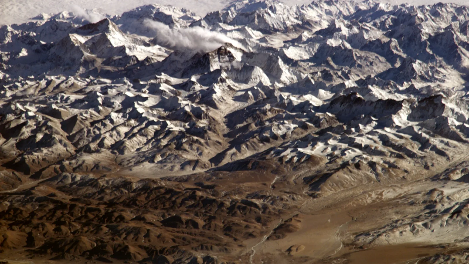 Snow-covered Himalayan ridges seen from high above