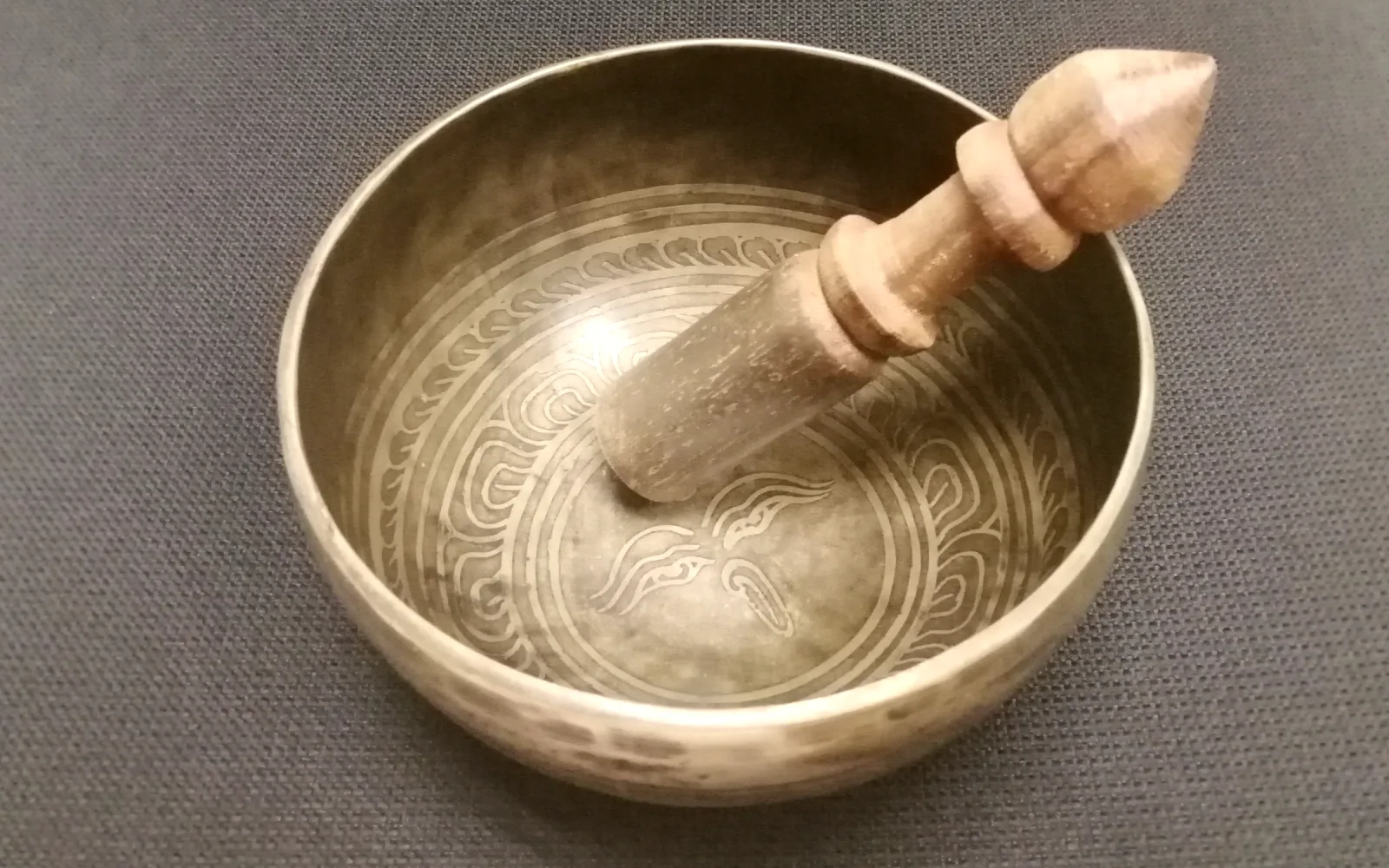 A Tibetan singing bowl with its wooden striker resting inside