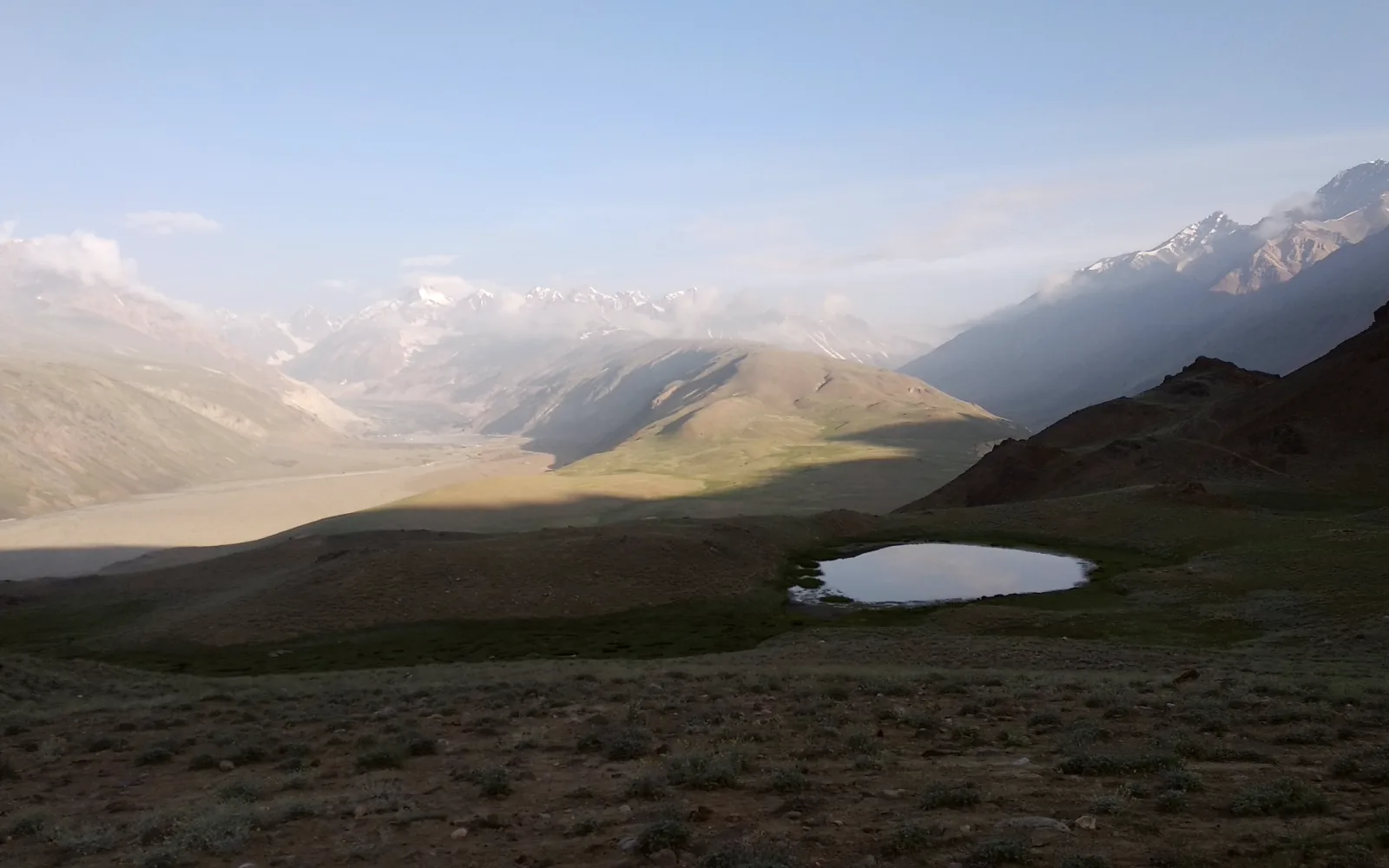 A small still lake on a high Himalayan plateau
